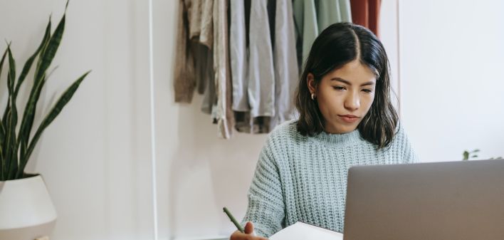 Focused blogger working on project at home